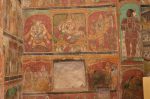 Title: Ramalinga Vilasam Palace Date: First half of the 18th century, restored Description: Top row: Srivaishnava divyadeshams; Bhu Varahasvami (Sri Mushnam); Lakshmi Narasimha (Lower Ahobilam); Trivikrama, Tirukoyilur (?)(Kanchipuram); Bottom row: The Jagannatha triad (Puri); King Bali and Vamana; On the wall projection on the right: Mutu Vijaya Raghunata Setupati in worshipful attitude; Below lady holding the pallu of her sari. Location: Tamil Nadu Palace;Ramanathapuram Positioning: Room 1, east wall, north corner