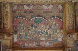 Title: Minakshi Sundareshvara Temple; Madurai Date: c. 1700Description: The wedding of Minakshi and Sundareshvara, witnessed by Queen Mangammal, Vijayaranga Chokkanatha (on the right) and the dalavay (minister) Ramappaiya on the left. Location: Tamil Nadu Temple;Minakshi Sundareshvara Temple;Madurai Positioning: Kilikuttu mandapa, ceiling