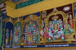Title: Andal Temple; Srivilliputtur Date: Paintings, late 20th centuryDescription: 108 Srivaishnava divyadeshams. 1) Sri Nampi of Kaliyan Tirunaiyur (Nacchiyarkoyil) standing. On the left are Tirumangai alvar and Medhavi rishi. 2) Sri Saranathan of Tirucherai standing flanked by his consorts; 3) Sri Uyyavanta Perumal (Vinnagara Perumal) of Tiru Nandipura Vinnagaram, seated flanked by his consorts. On the left is Nandi and on the right, Sibi chakravarti. In the upper left corner, the shrine of Shanbagavalli Thayar and in the upper right corner, the Nandi pushkarini (tank). Location: Tamil Nadu Temple;Andal Temple;Srivilliputtur Positioning: Inner prakara, west wall
