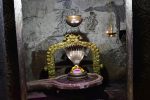Title: Virabhadraswamy Temple; Lepakshi Date: 15th century (?)Description: Papanasheshvara (Shiva) shrine in the mahamandapa, east of the Virabhadra shrine.  According the the legend it was the first shrine on Kurmasaila hill, and was built by the sage Agastya. In the background, carved onto the rock: Shiva as Bhikshatana. Location: Andhra Pradesh Temple;Virabhadraswamy Temple;Lepakshi Positioning: Mahamandapa, east side