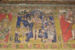 Title: Atmanatha Temple; Avudaiyarkoyil (Tirupperunturai) Date: Paintings: late 19th, early 20th centuryDescription: Shiva as Kirata flanked by Ganesha and by Parvati as Kirati carrying baby Skanda on her hip and with four dogs on the leash. Location: Tamil Nadu Temple;Atmanatha Temple;Avudaiyarkoyil Positioning: Sivananda Manikkavachakar shrine, prakara, west wall