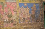 Title: Atmanatha Temple; Avudaiyarkoyil (Tirupperunturai) Date: Paintings: late 19th, early 20th centuryDescription: On the left a king, perhaps Anapaya (Kulottunga Chola), a minister and Sekkilar paying homage to Vighneshvara (Ganesha); on the right a group of devotees, one of them with a lit lamp, stands before a stambha. Location: Tamil Nadu Temple;Atmanatha Temple;Avudaiyarkloyil Positioning: Sivananda Manikkavachakar shrine, prakara, north wall