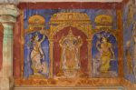 Title: Kapardishvara Temple complex; Periyanayaki shrine; Tiruvalanjuli Date: Paintings, early 20th centuryDescription: Vaishnavi (?) standing carrying in the upper pair of hands chakra and lotus, flanked by fly whisk bearers. Location: Tamil Nadu Temple;Kapardishvara Temple complex;Tiruvalanjuli Positioning: Periyanayaki shrine, walls of the vimana, south face